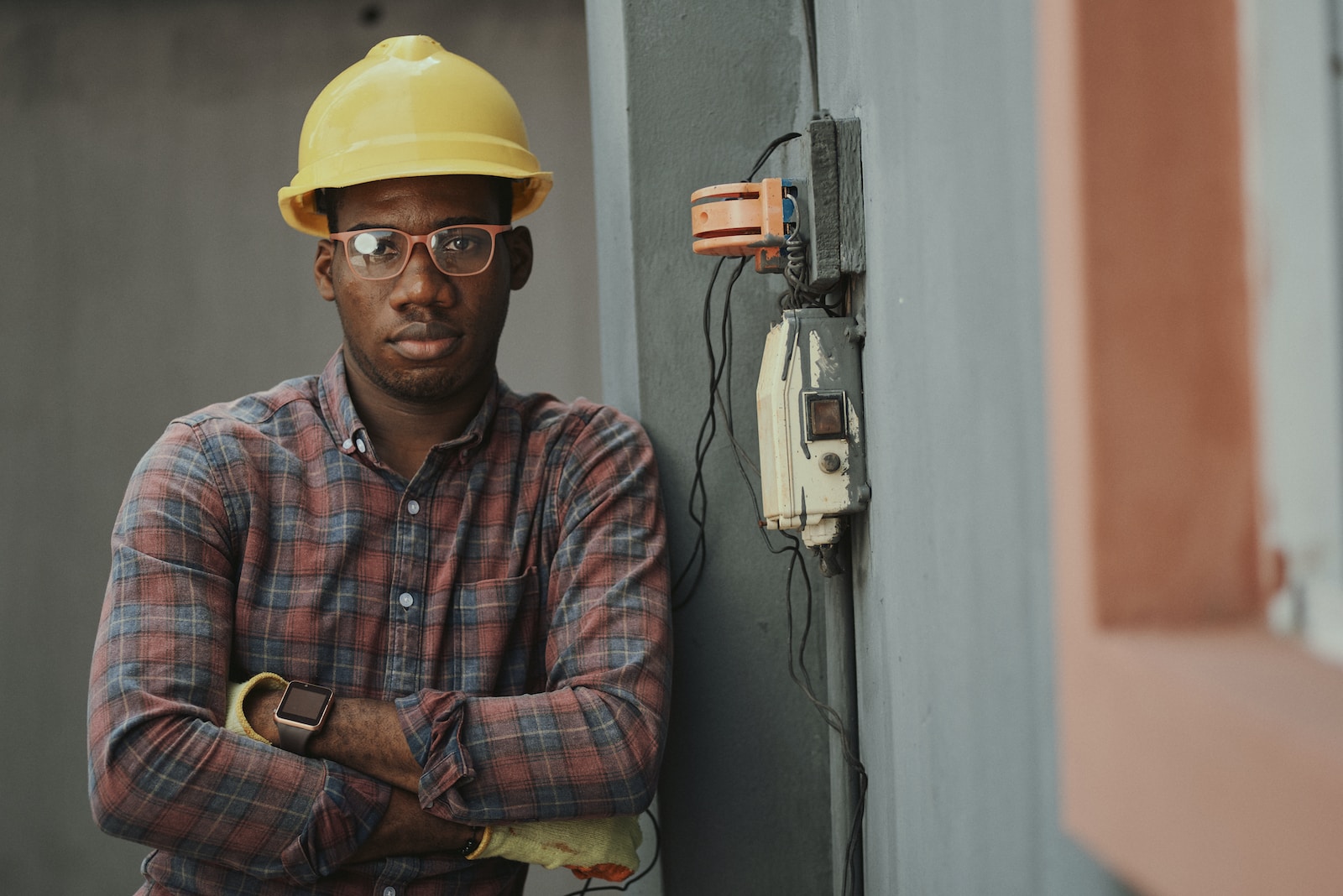 man in blue white and red plaid button up shirt wearing yellow hard hat